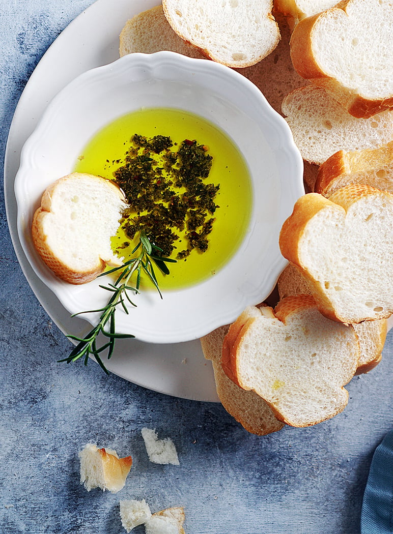 herbs & olive oil in a bowl with French bread