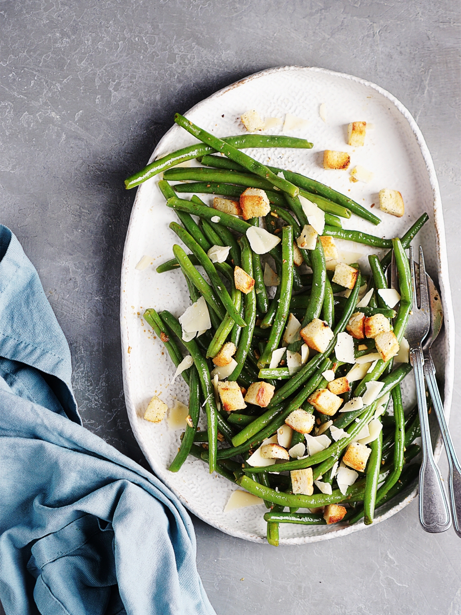 Green Bean Salad on a plate with salad dressing & croutons