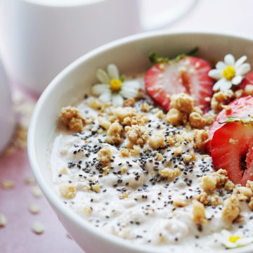Close up photo of oats and greek yogurt in a white bowl