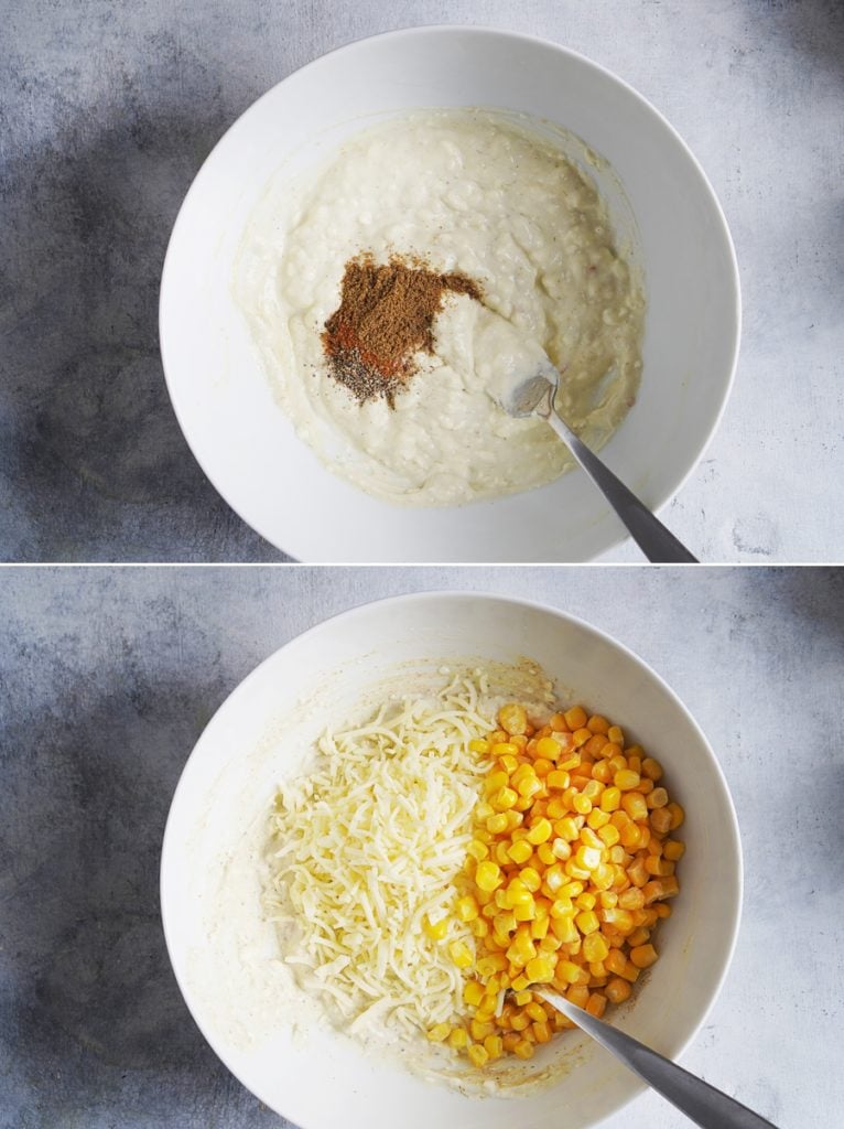 A white mixing bowl showing shredded white cheese and corn.