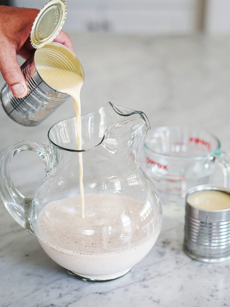 Pouring evaporated milk in a jar