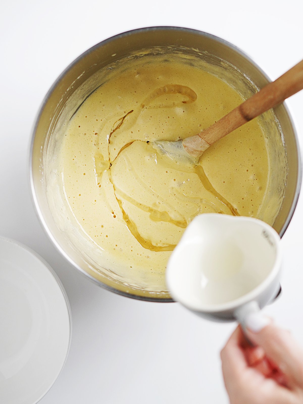 Adding oil in the cake batter in the mixing bowl