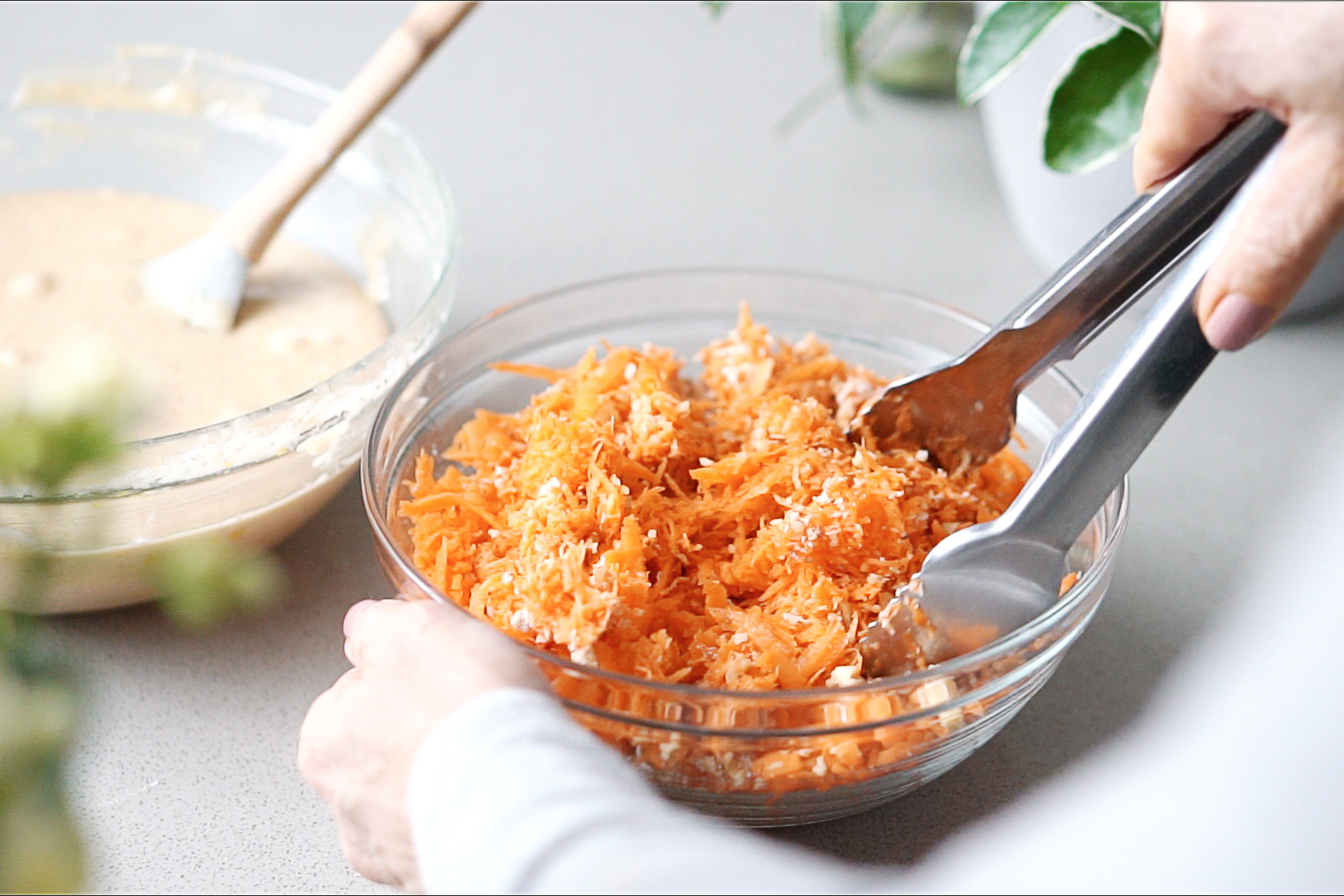 Mixing shredded carrots with pecans, and 1 tablespoon of flour