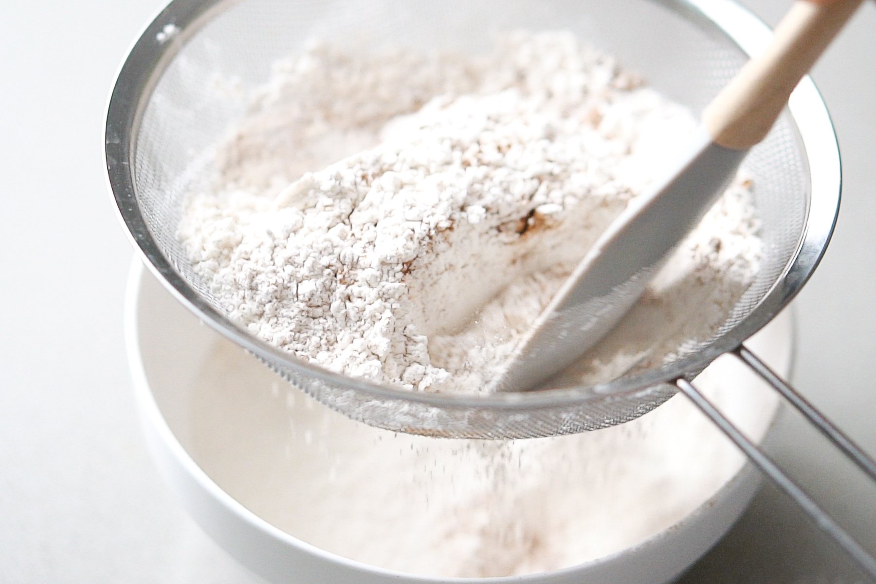 Sifting flour, baking soda, salt and cinammon