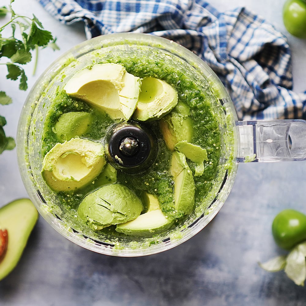 Salsa Verde with avocado chunks in a food processor