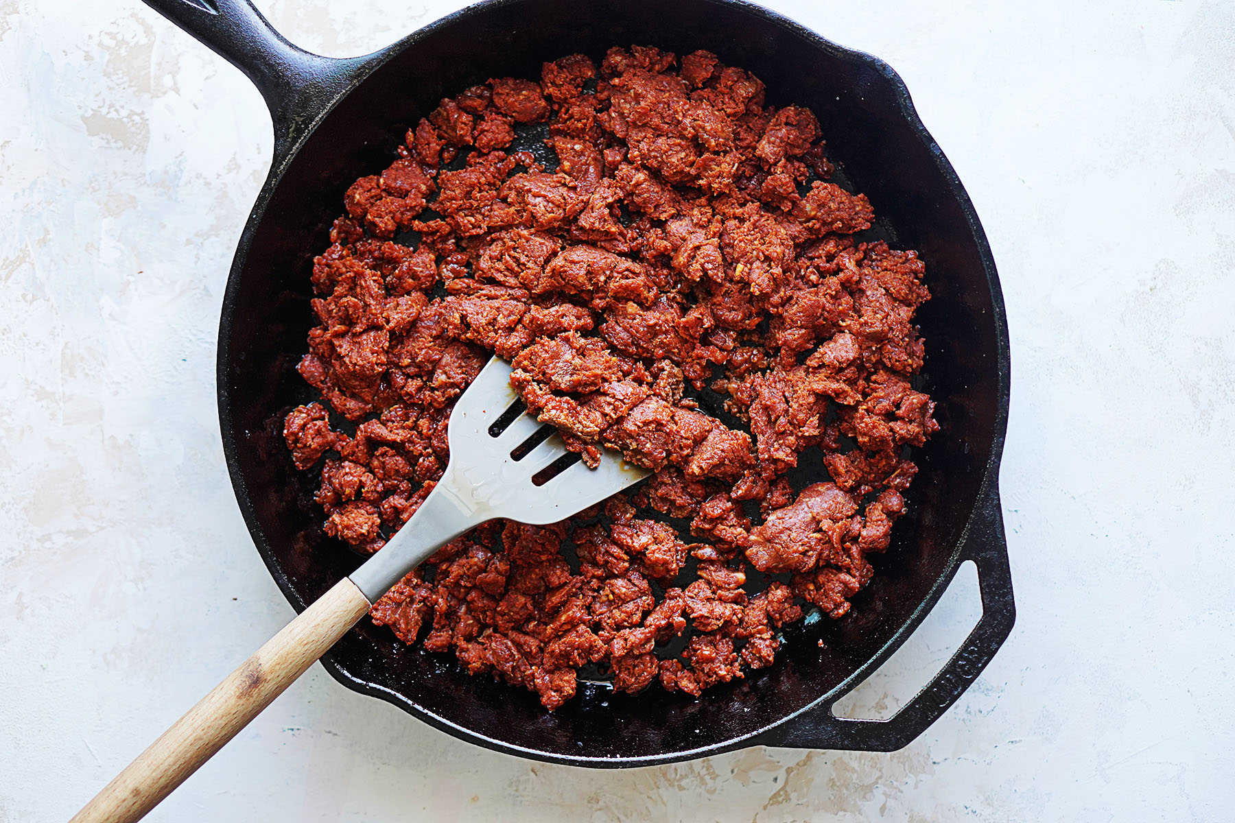 A cast iron skillet cooking chorizo