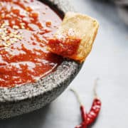 A molcajete with red salsa