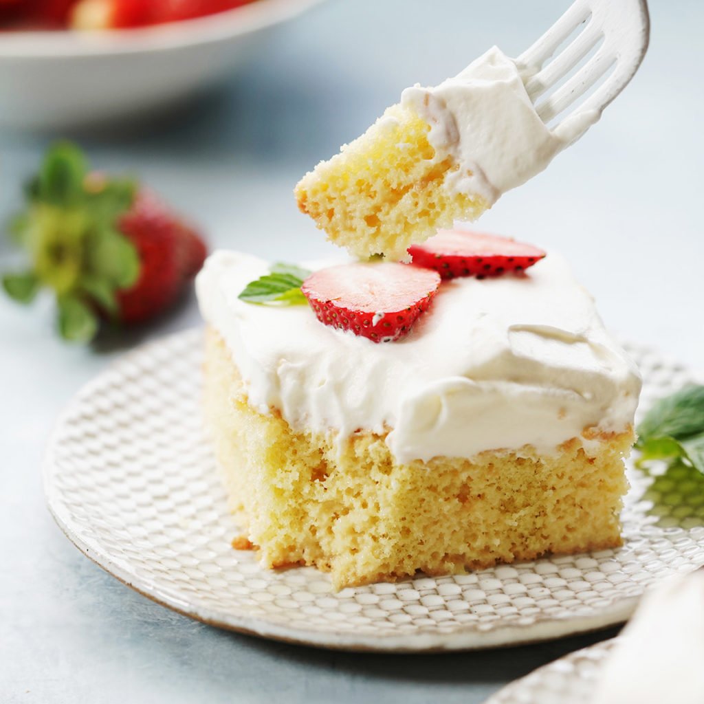 a slice of Tres leches cake with a fork