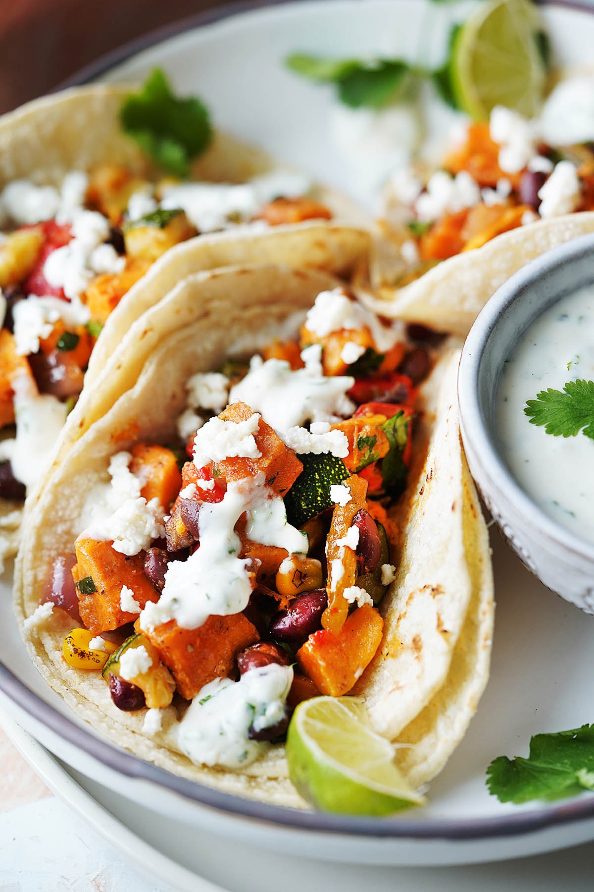 close up image of two tacos with veggies inside
