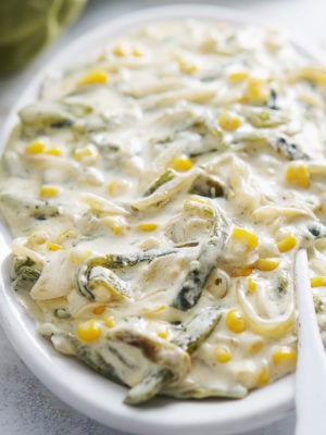 A large oval serving plate with chiles poblanos in a creamy white sauce.
