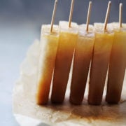5 popsicles standing up leaning on each other.