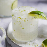 One cocktail glass garnished with a slice of lime.
