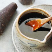 A small bowl with dark syrup.