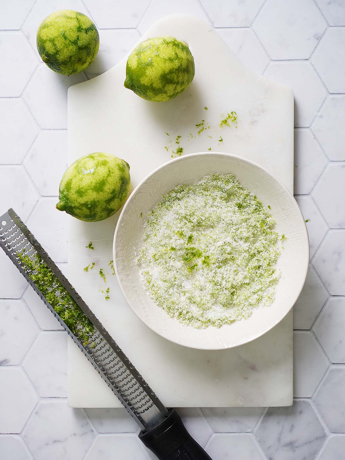 A bowl with sugar and lime zest.