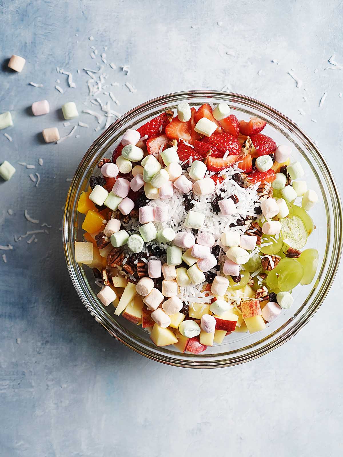Large clear bowl with Mexican fruit salad.