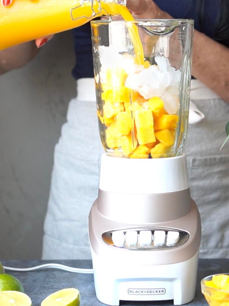Frozen Mango chunks and ice in a blender.