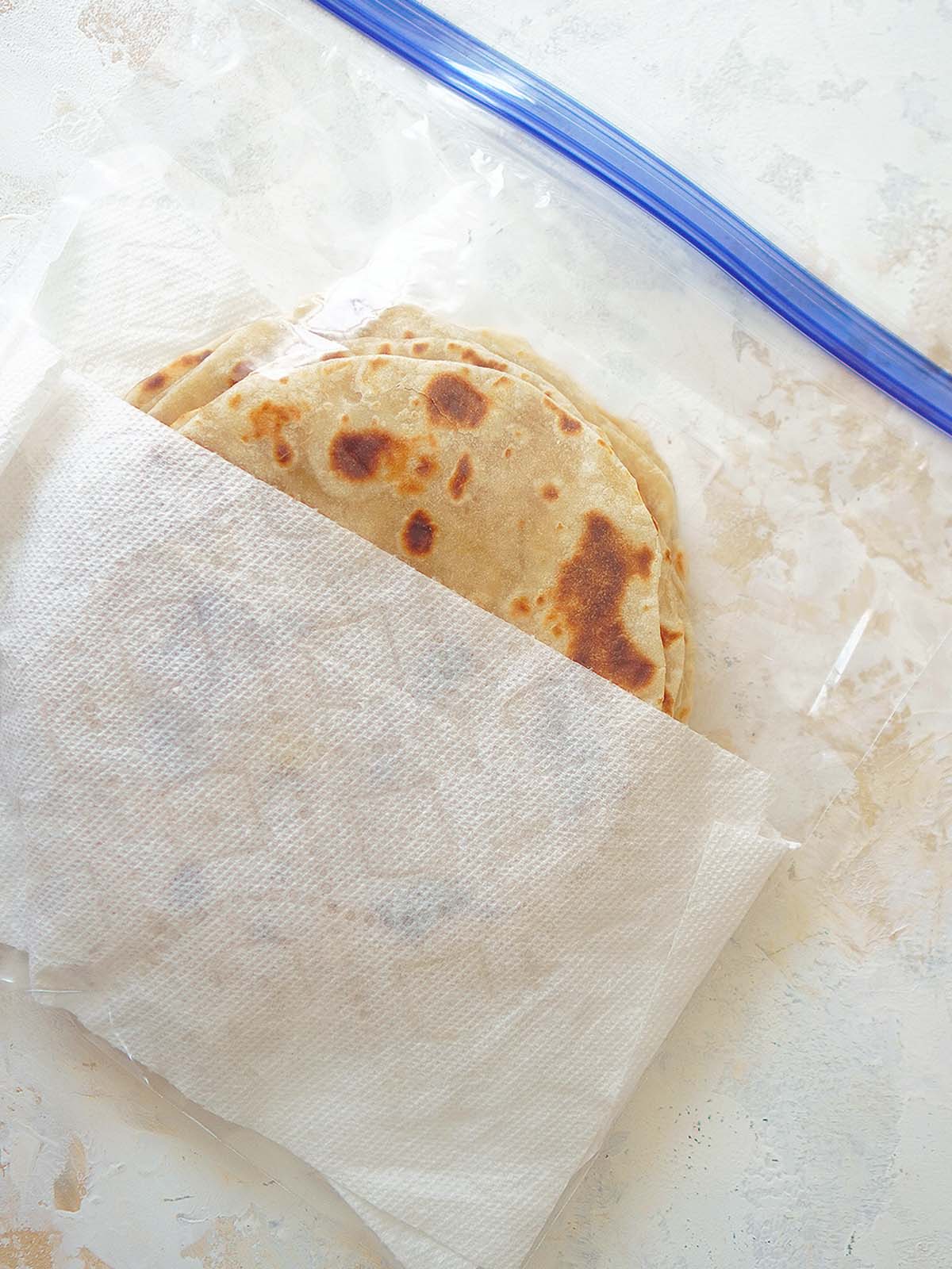 Tortillas stored inside a ziploc bag along with paper towels inside too.