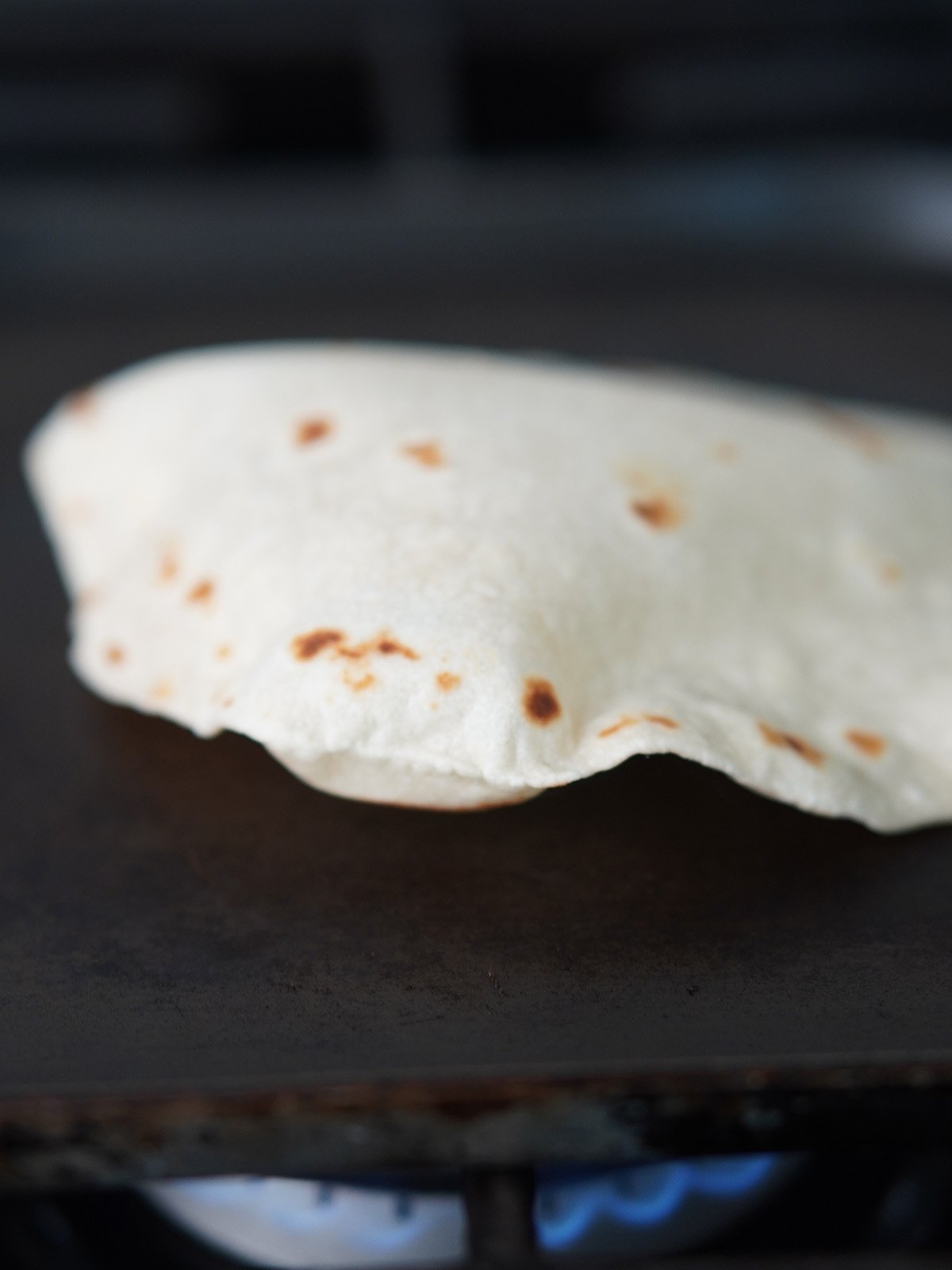 Cooking a tortilla on a skillet.