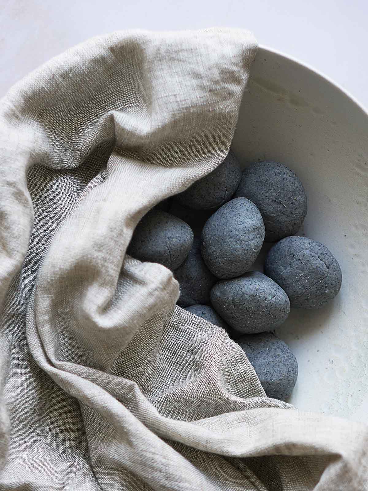 Masa balls covered by a linen kitchen towel.