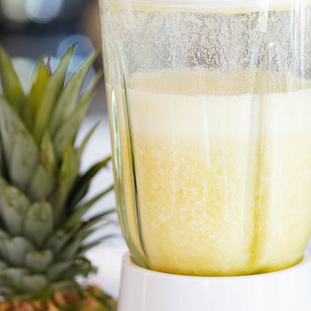 Pineapple water blended inside a blender's glass.
