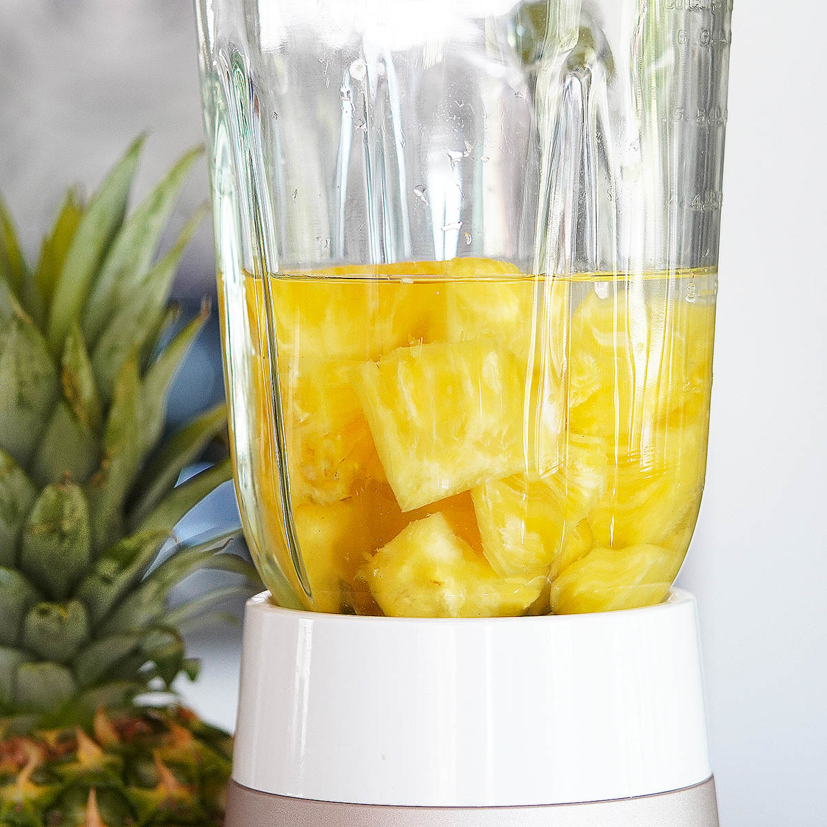 Pineapple chunks in a blender with some water.