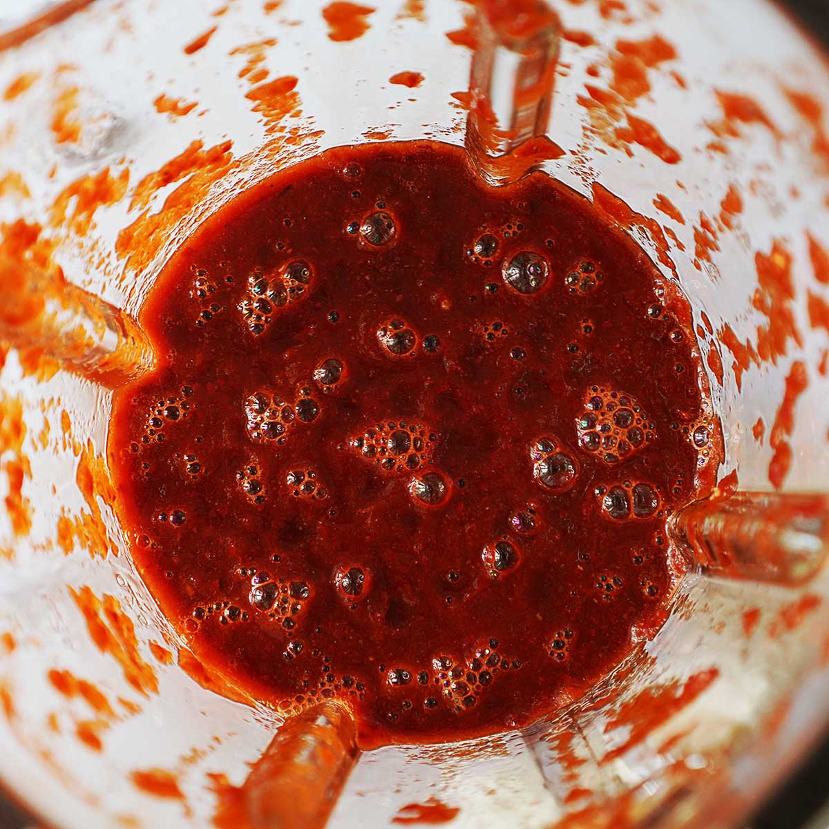 Pureed red sauce in a blender's glass.