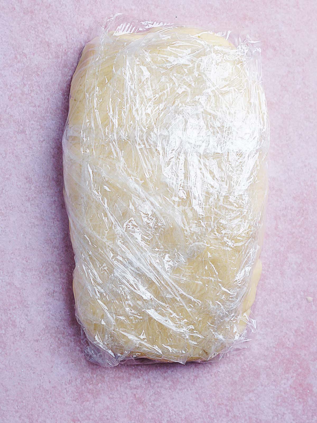 Cookie dough wrapped in plastic wrap.