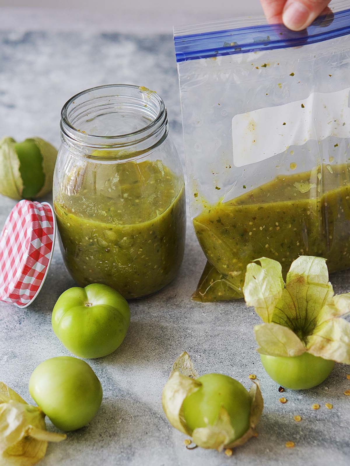 Tomatillo sauce in a ziploc bag and some in a glass container.