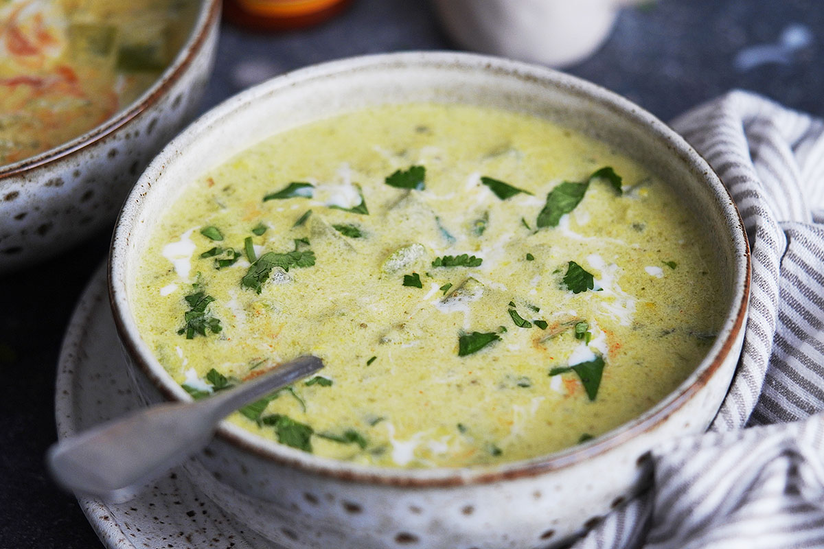 A bowl with with a creamy soup garnished with cilantro.