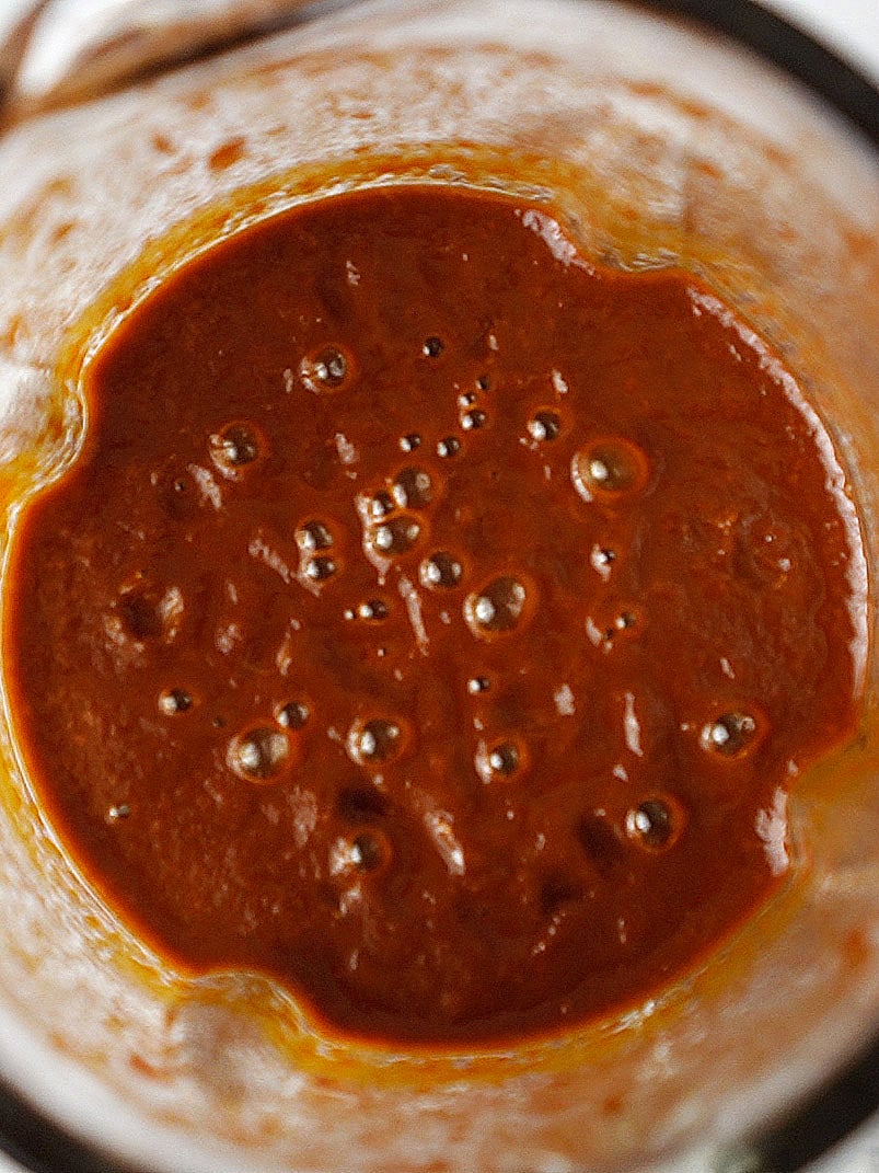 Red sauce inside a blender's cup.