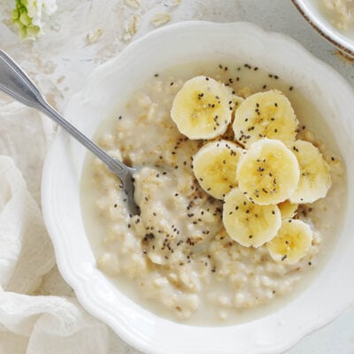 A bowl of Avena with bananas sprinkled with chia seeds.
