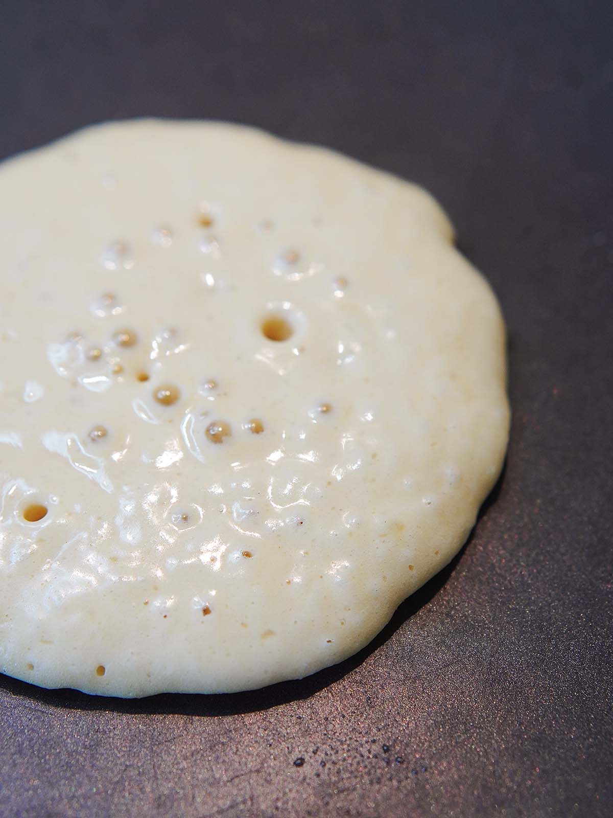 Cooking a pancake on a griddle.