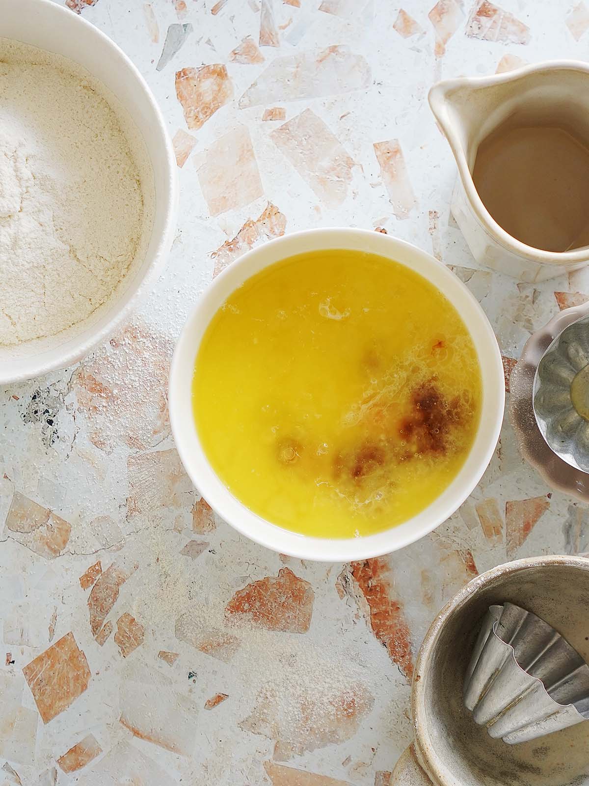 A bowl with the melted butter and vanilla.