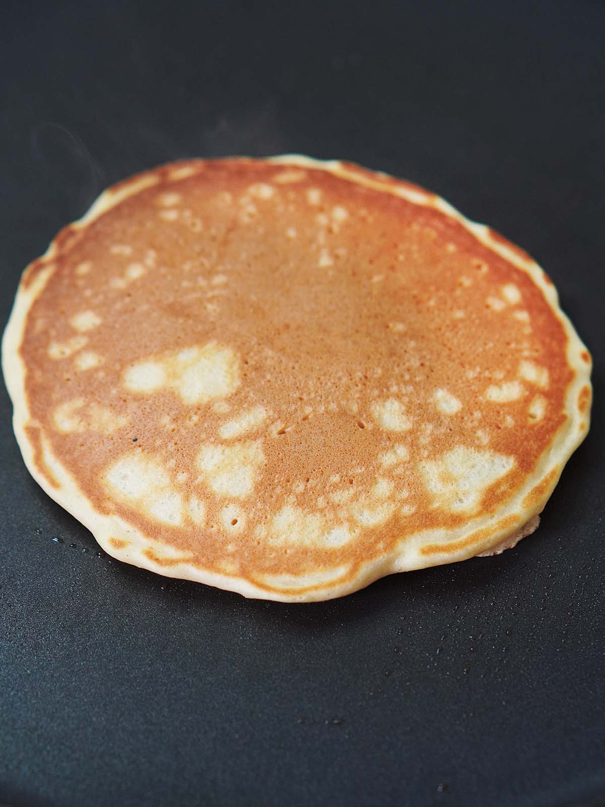 Cooking a pancake on a griddle.