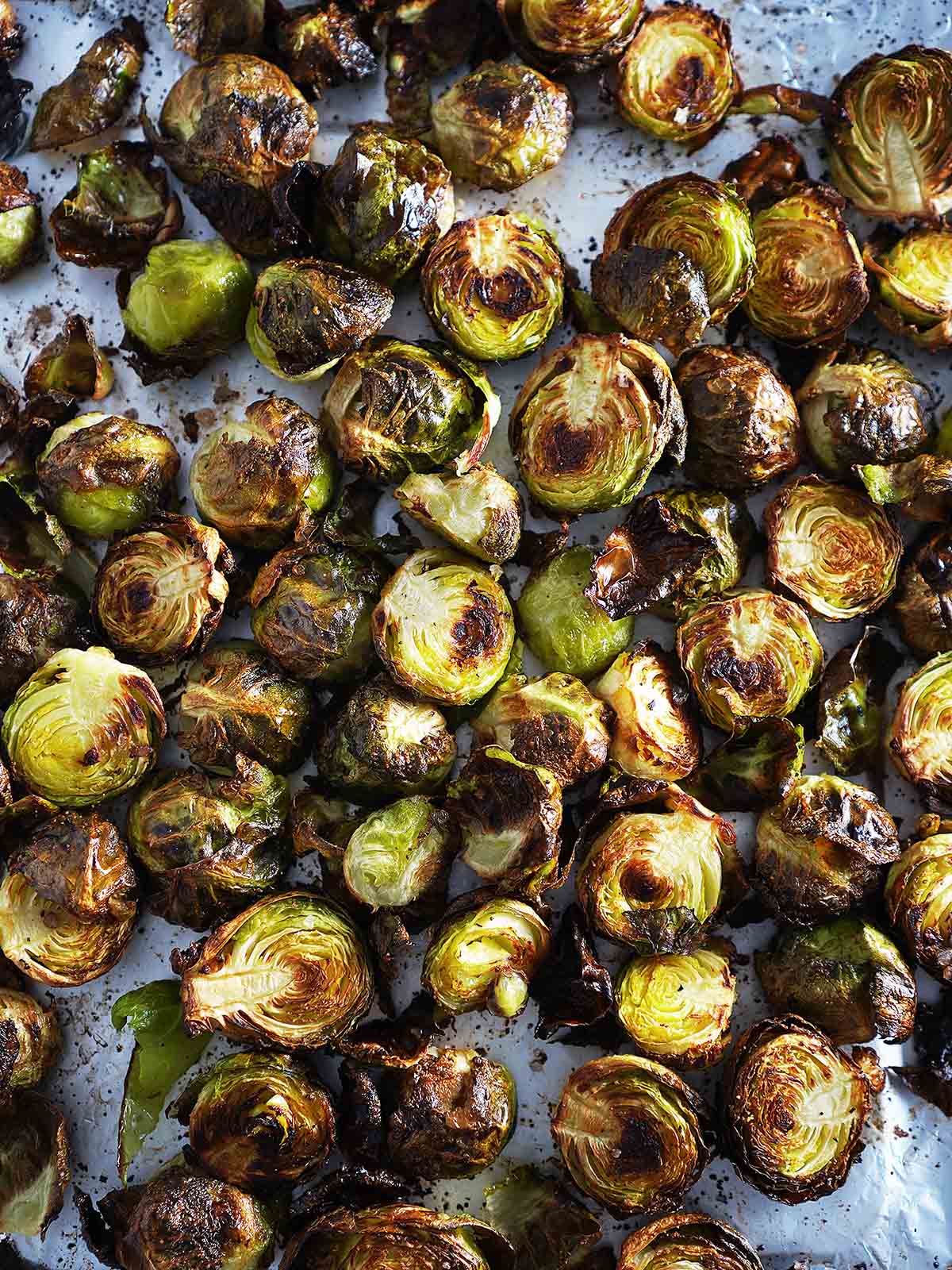 A baking tray with roasted sprouts.