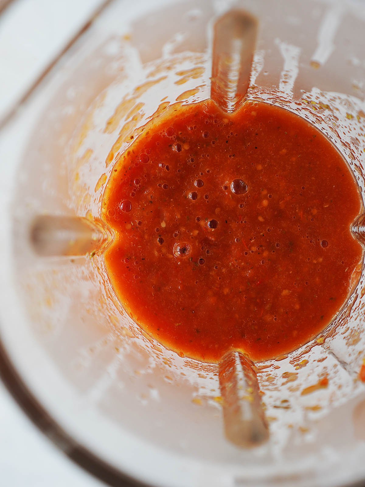 Blended salsa in a blender glass.