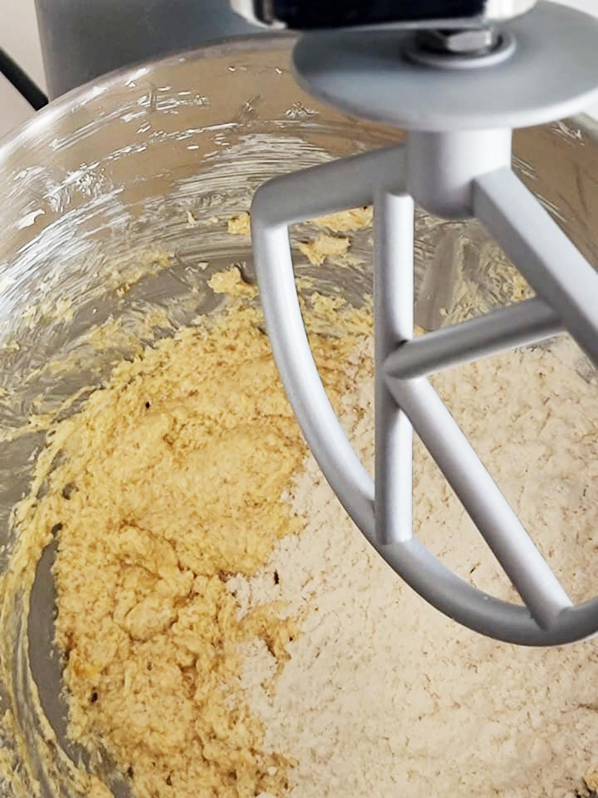 A stand mixer with dough inside.