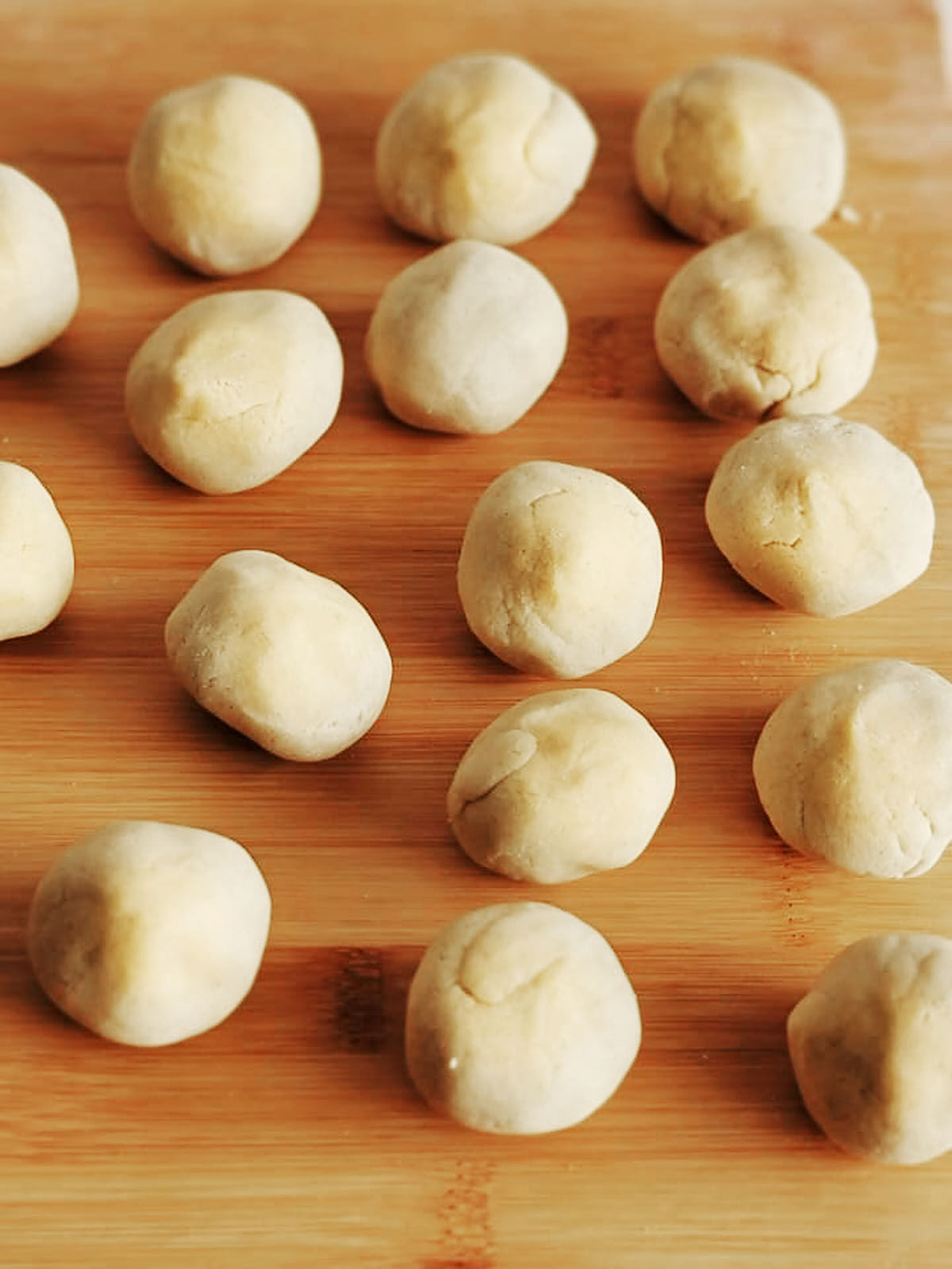 Masa dough balls on top of a work surface.