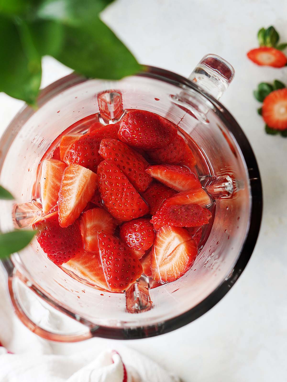 Chopped strawberries in a blender glass.
