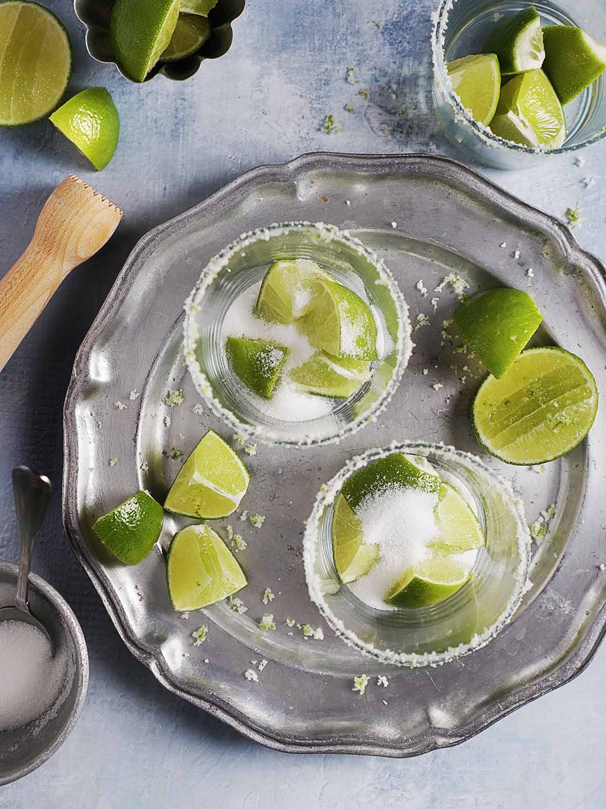Fresh limes with sugar in a cocktail glass.
