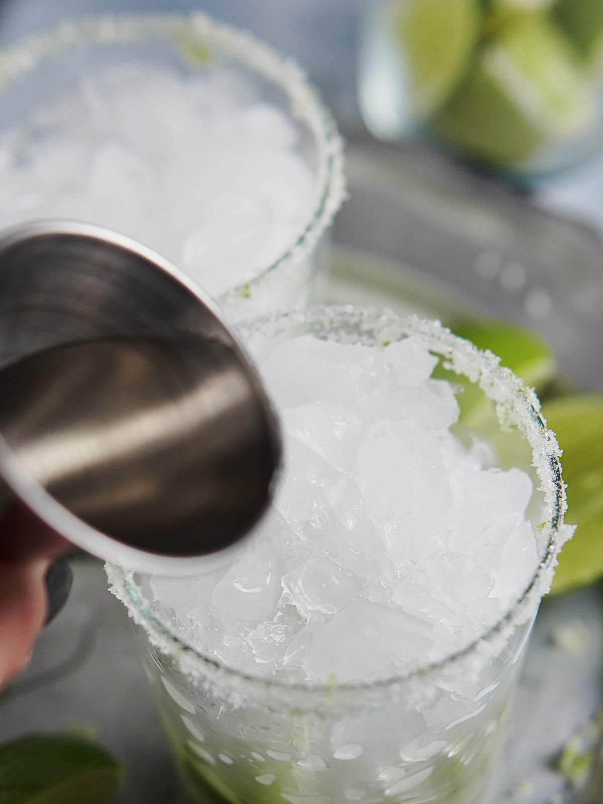 Adding Cachaca cocktail into a glass in ice.
