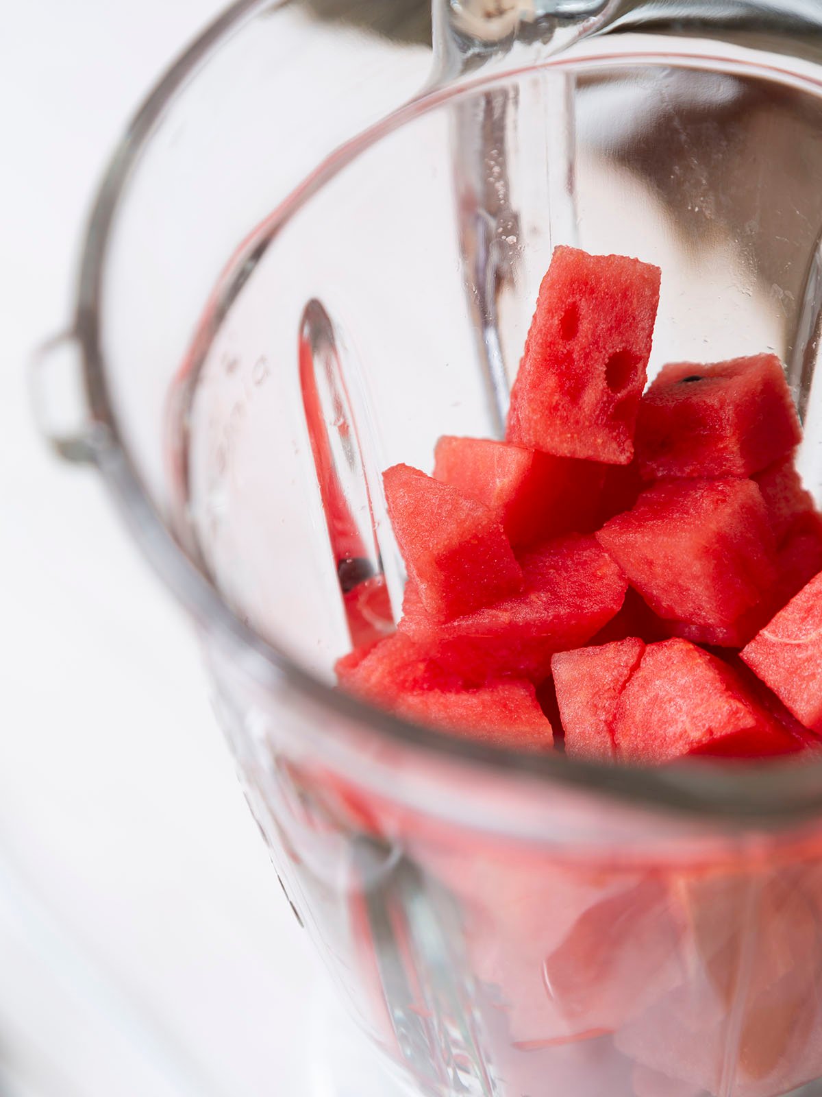 Watermelon cut in cube shape in food blender prepared for make juice.