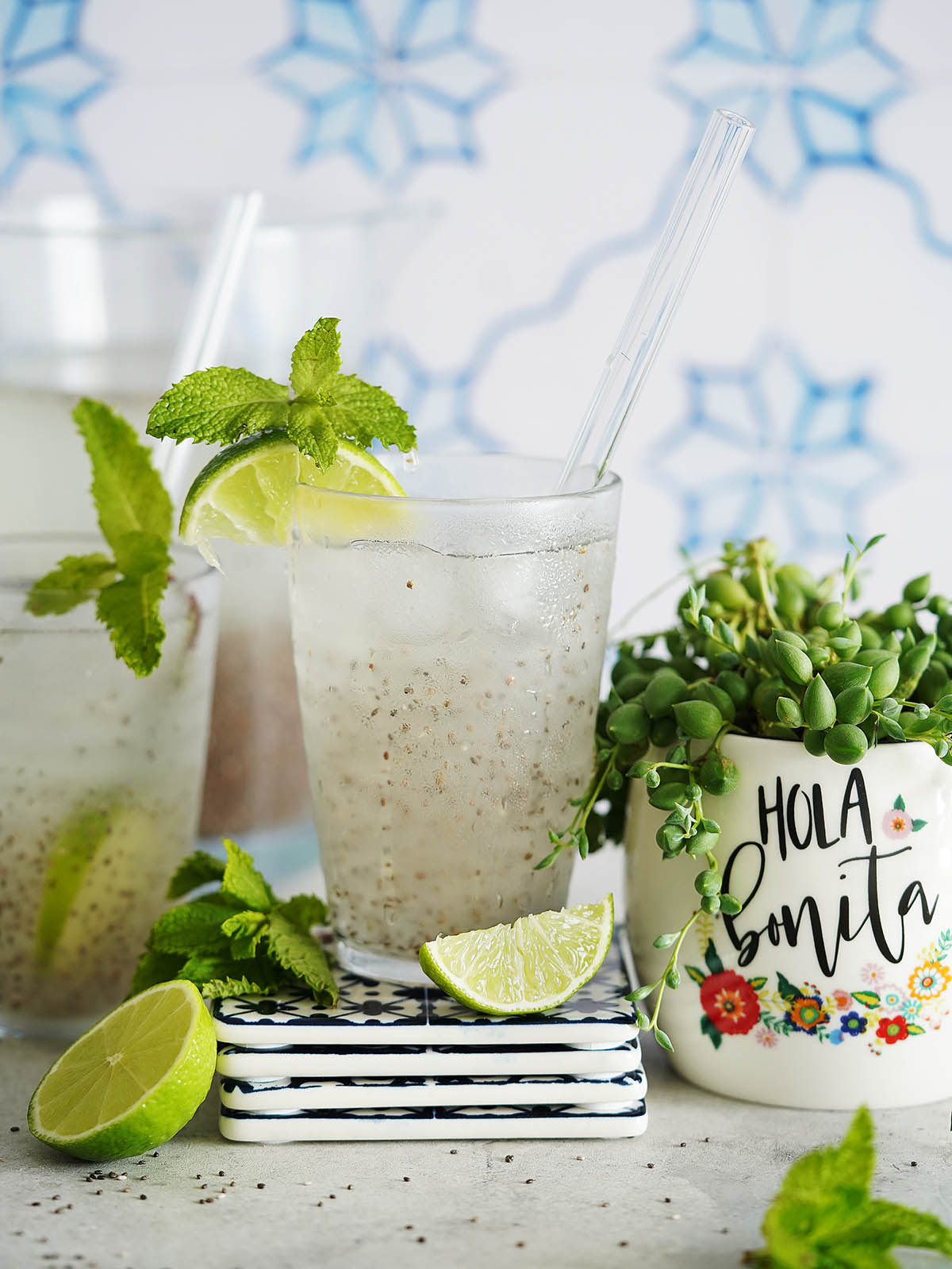 Agua Con Chia & Limon in 3 clear glasses filled with ice.