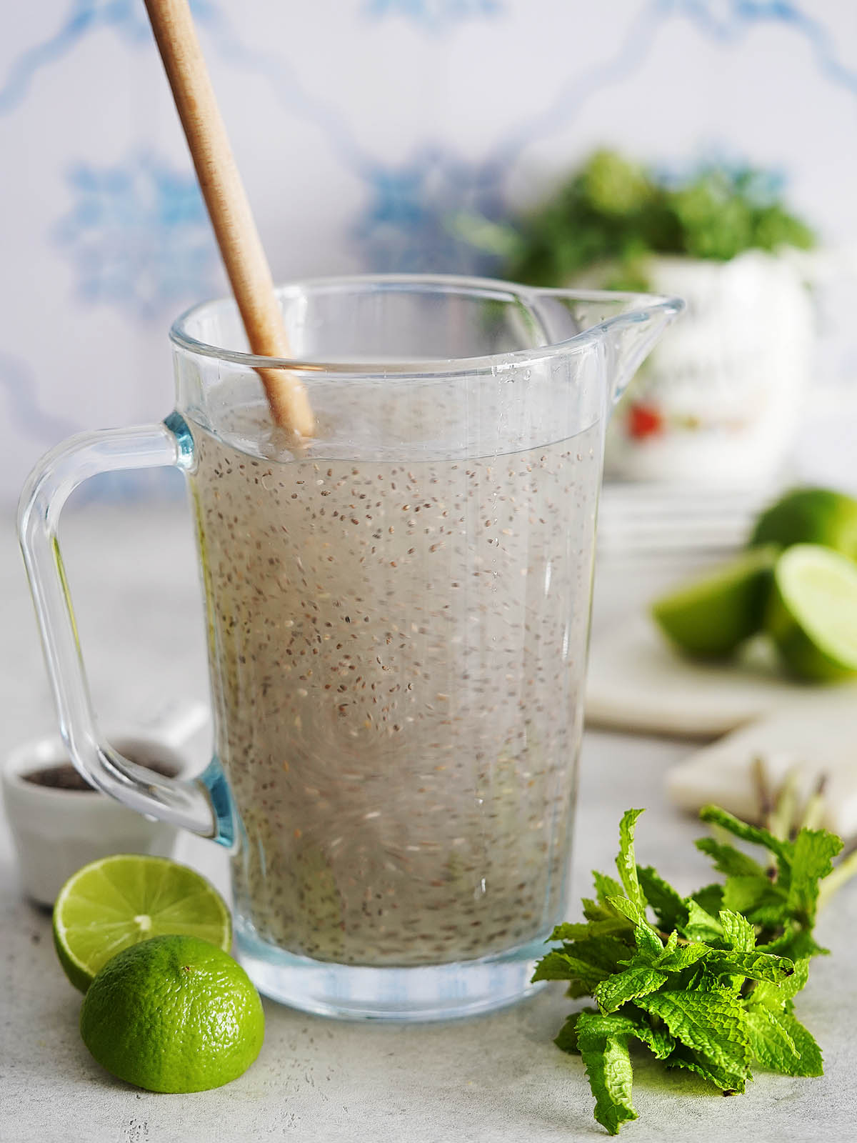 Stirring a jar with water and limes with chia seeds.