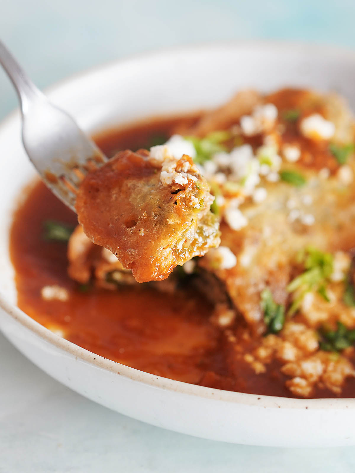 A fork holding a slice of chile relleno.