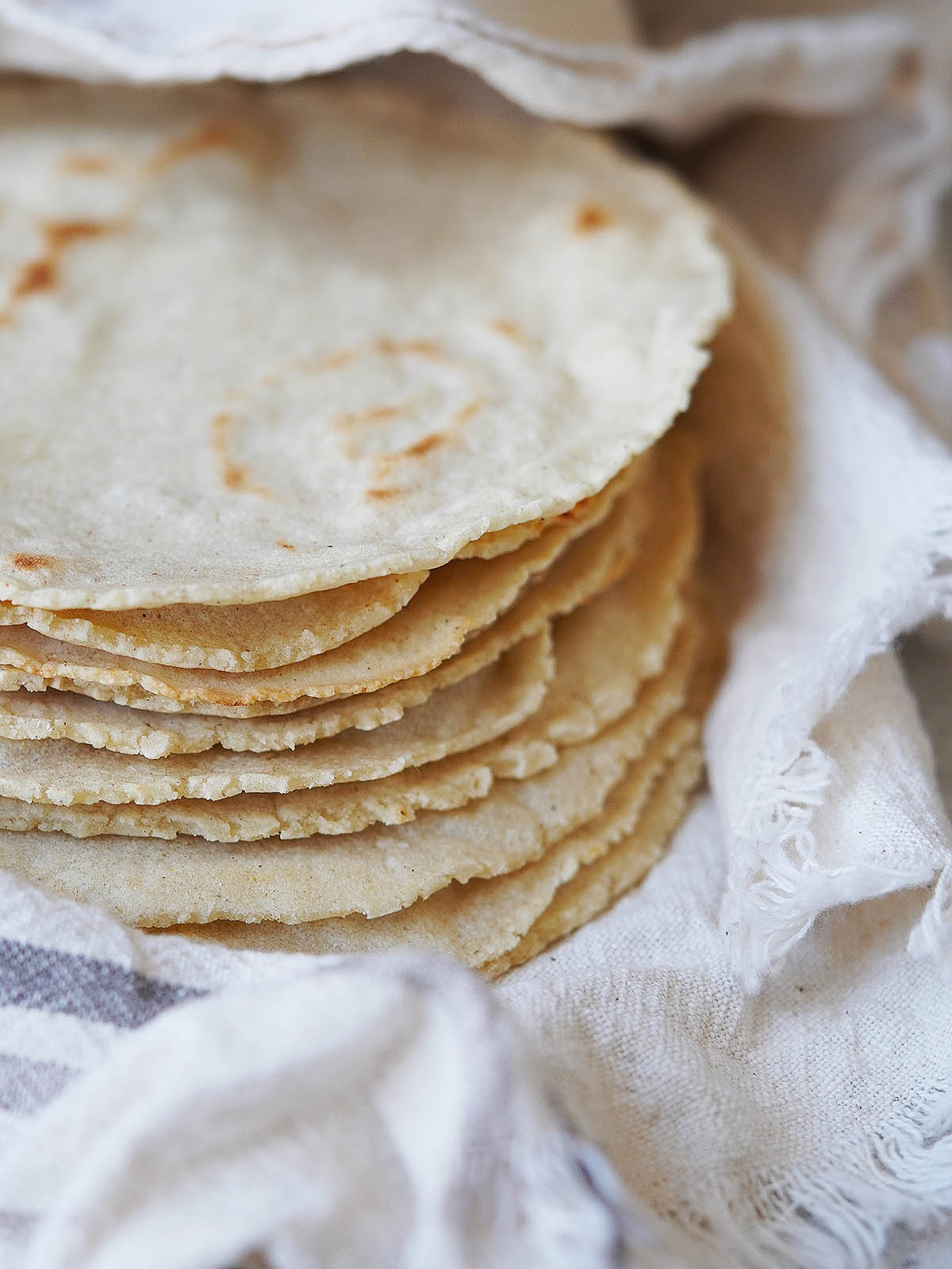A stack of tortillas inside a kitchen towel.