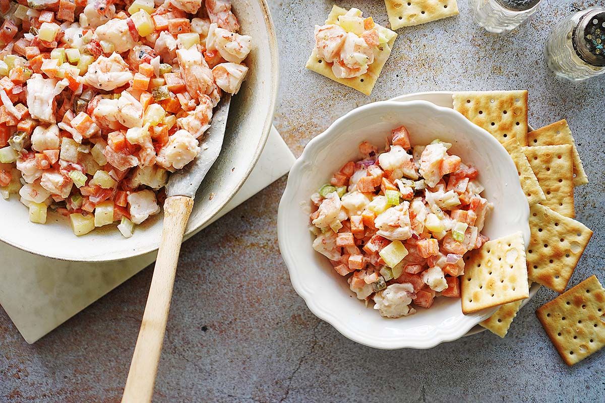Shrimp Salad in a small bowl with saltines around the bowl.