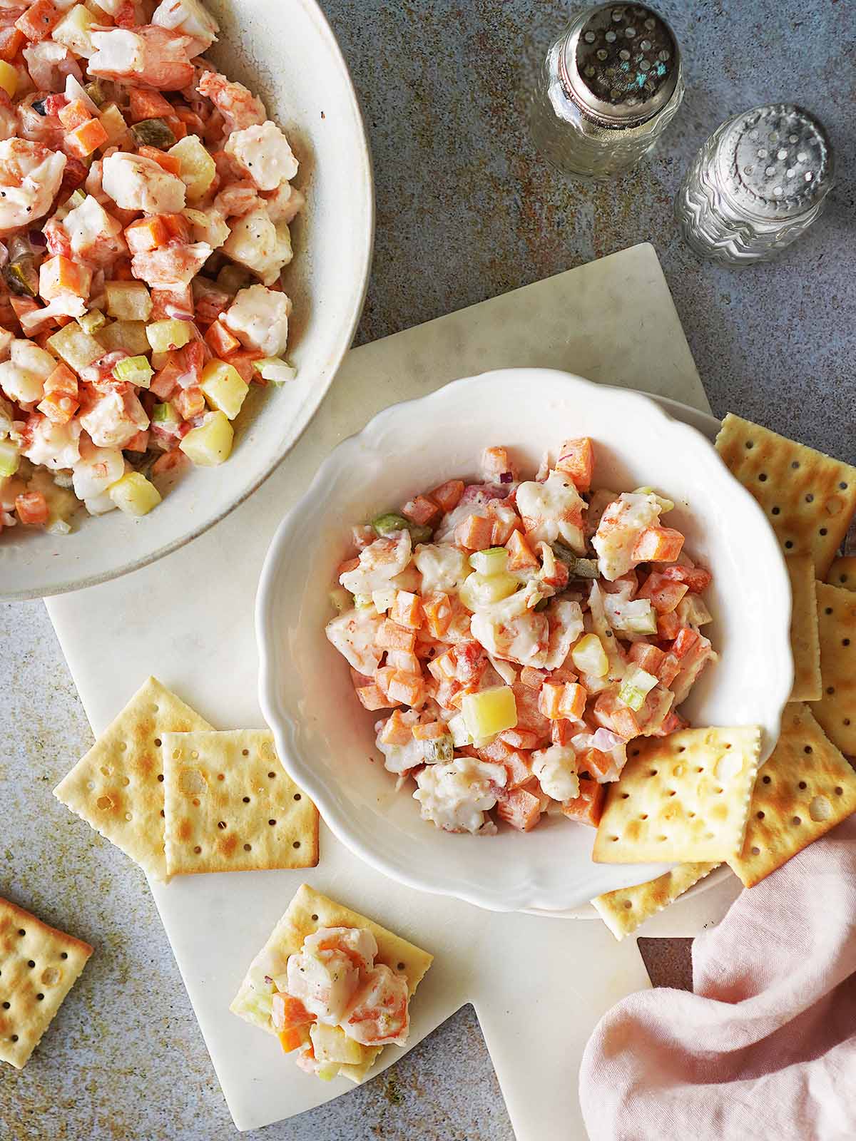 Shrimp Salad in a small bowl with saltines around the bowl.