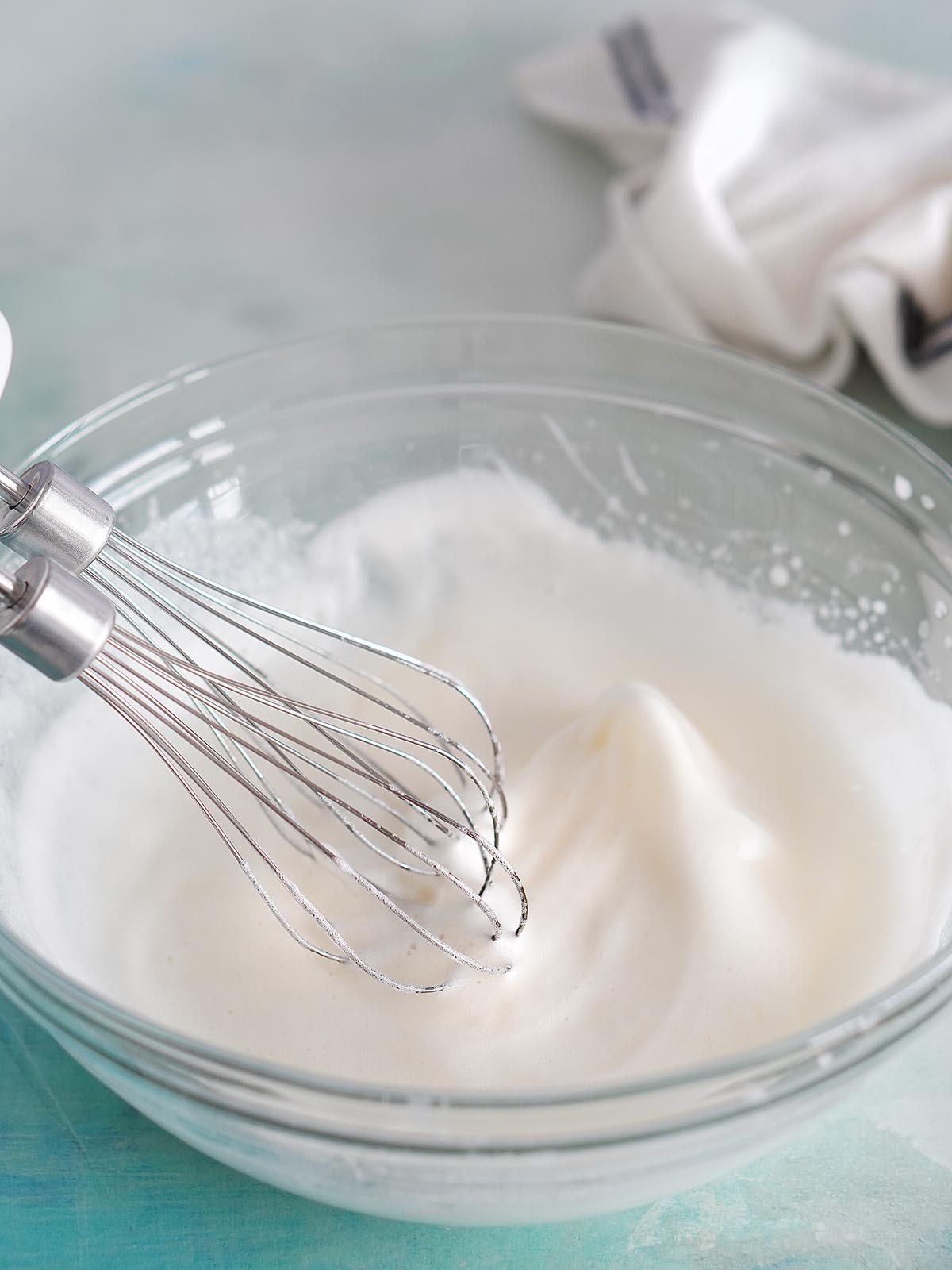 Whipping egg whites with a hand mixer.