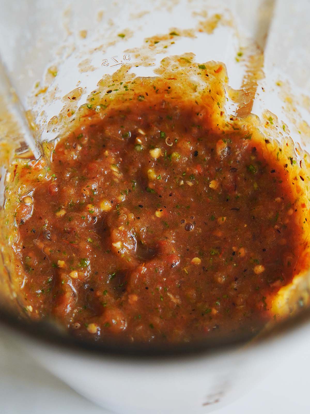 Freshly blended salsa in a blender's cup.